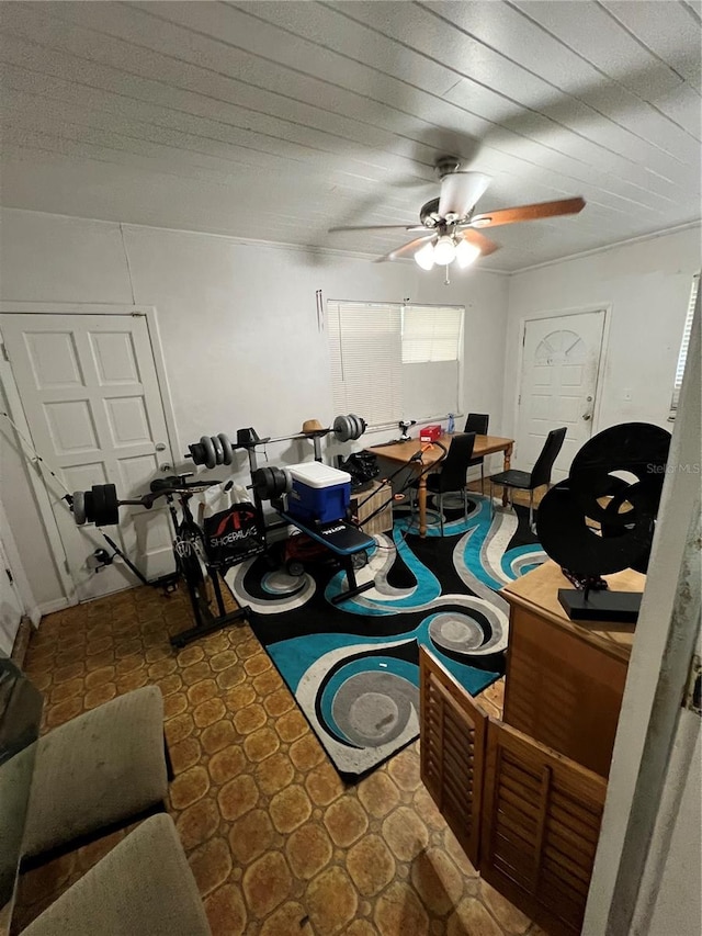 interior space featuring ceiling fan and dark tile patterned flooring