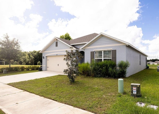 single story home featuring a front lawn and a garage