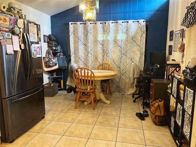 tiled dining room with lofted ceiling