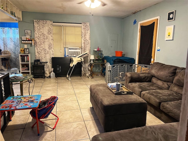 tiled living room with cooling unit, ceiling fan, and a wood stove