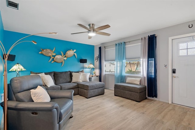 living room with light hardwood / wood-style floors and ceiling fan