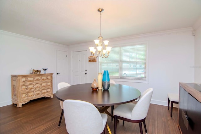 dining space featuring dark hardwood / wood-style floors, a notable chandelier, and ornamental molding