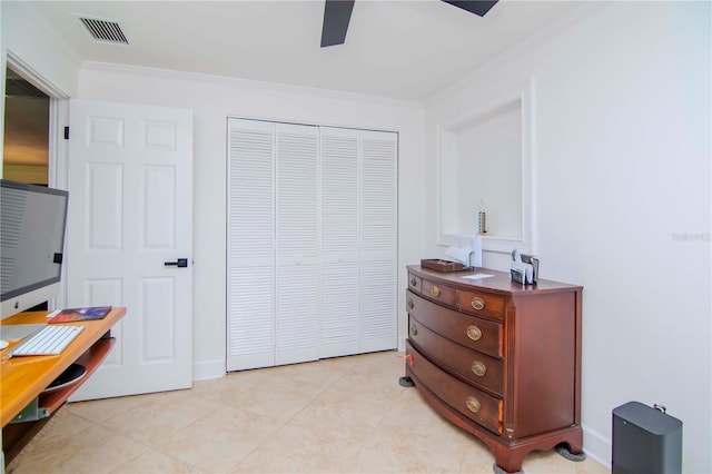 bedroom featuring a closet, ceiling fan, ornamental molding, and light tile patterned flooring