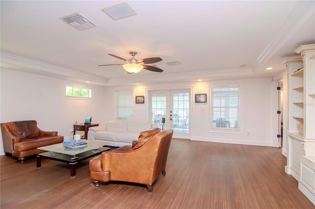 living room with crown molding, french doors, wood-type flooring, a raised ceiling, and ceiling fan