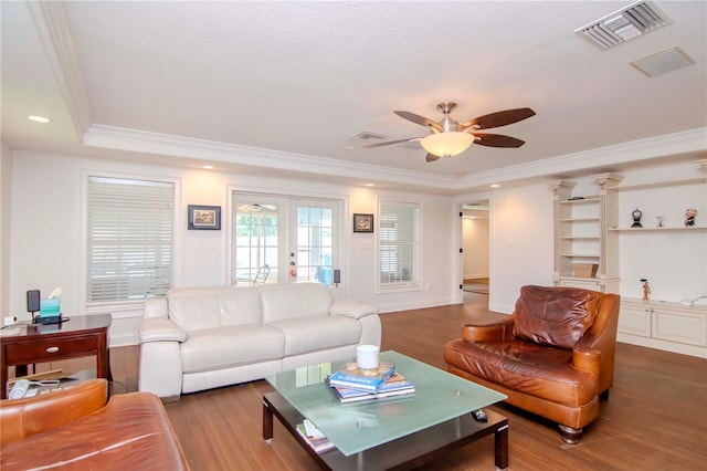 living room featuring a raised ceiling, crown molding, ceiling fan, french doors, and hardwood / wood-style flooring