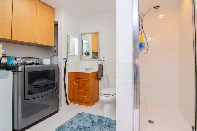 bathroom featuring tile patterned flooring, vanity, toilet, and walk in shower