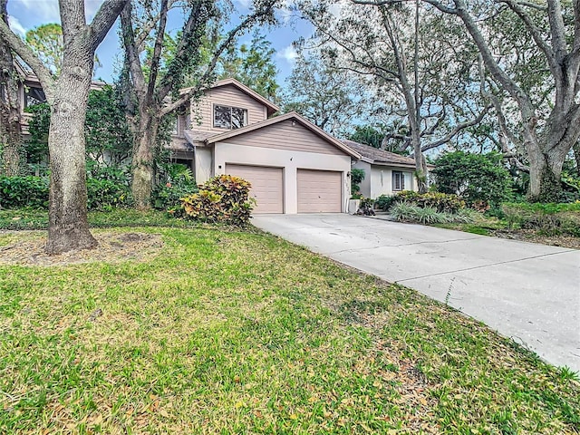 view of front of home featuring a front lawn and a garage