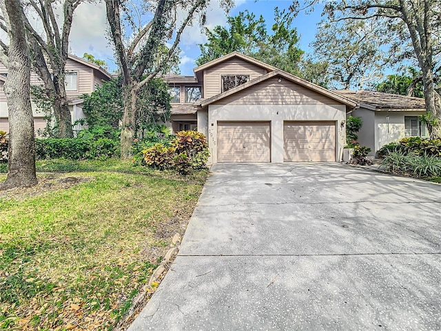 view of front of property featuring a front yard and a garage