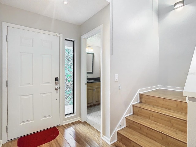 foyer featuring hardwood / wood-style floors and sink