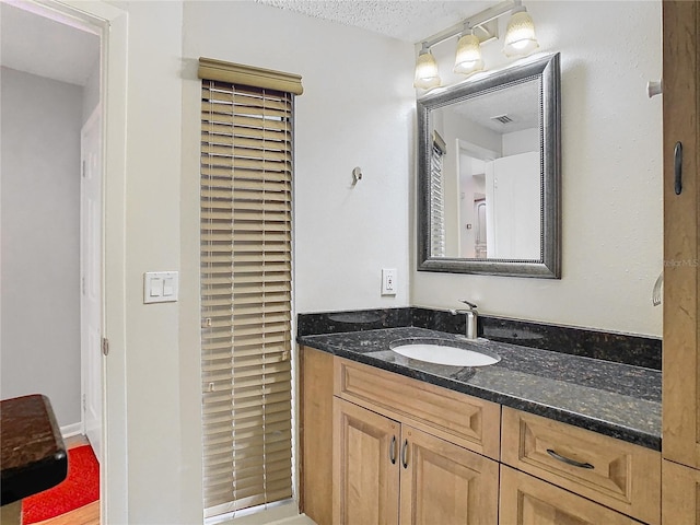 bathroom with vanity and a textured ceiling