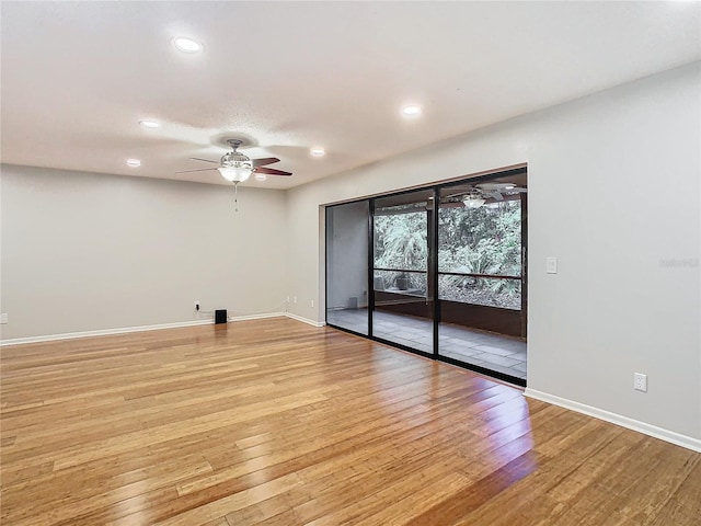 spare room with light hardwood / wood-style flooring and ceiling fan