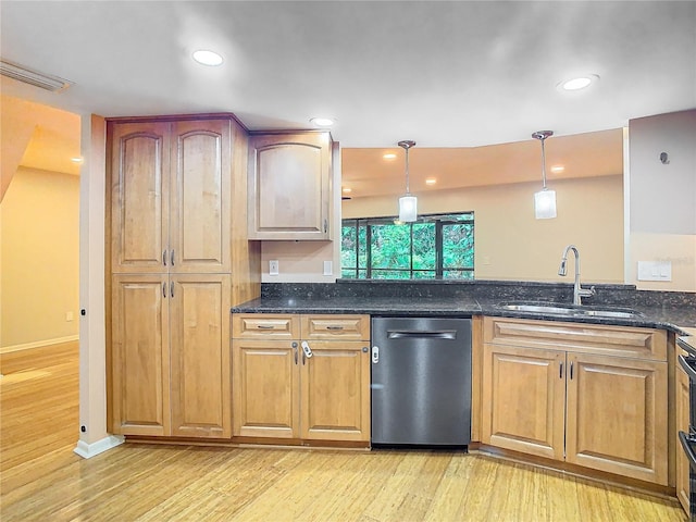 kitchen with light hardwood / wood-style flooring, dark stone countertops, stainless steel dishwasher, and sink