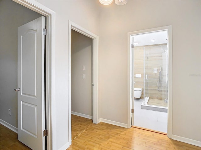 hallway with light hardwood / wood-style floors