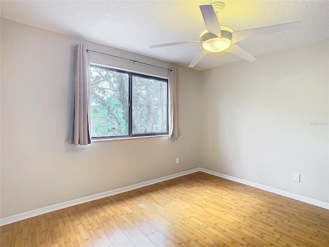 spare room featuring ceiling fan, a textured ceiling, and light wood-type flooring