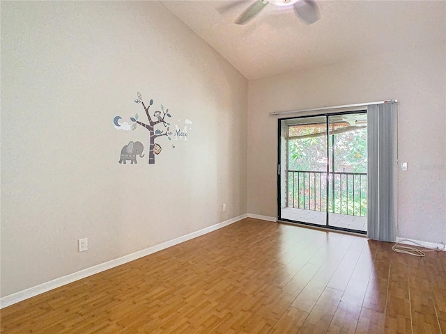 unfurnished room with lofted ceiling, hardwood / wood-style flooring, and ceiling fan