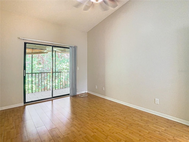 empty room featuring vaulted ceiling, wood-type flooring, and ceiling fan