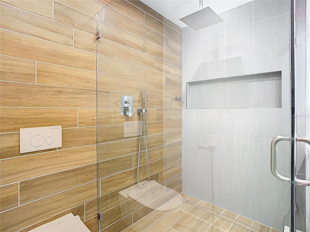 bathroom featuring a shower with shower door