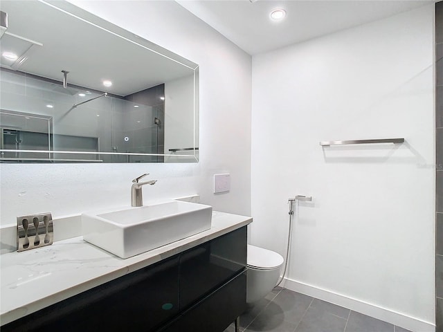 bathroom with toilet, vanity, a shower, and tile patterned floors