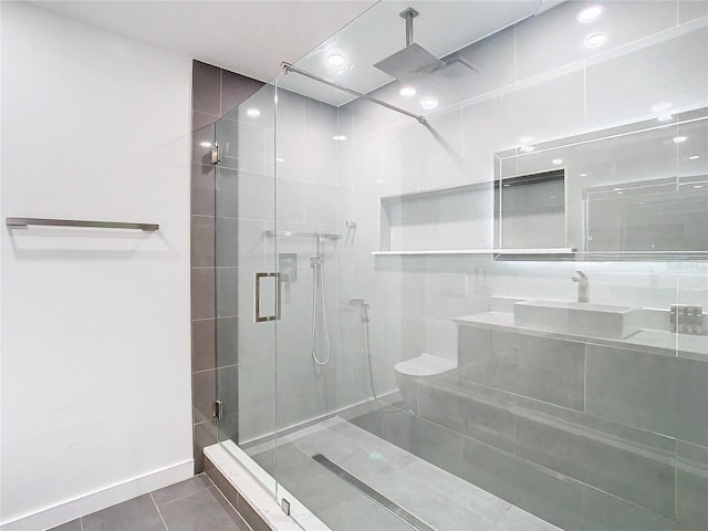 bathroom featuring sink, tile patterned flooring, and an enclosed shower