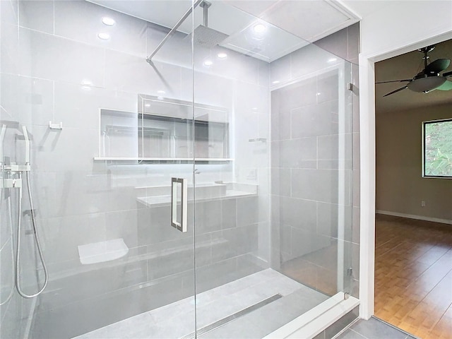 bathroom with ceiling fan, hardwood / wood-style flooring, and walk in shower