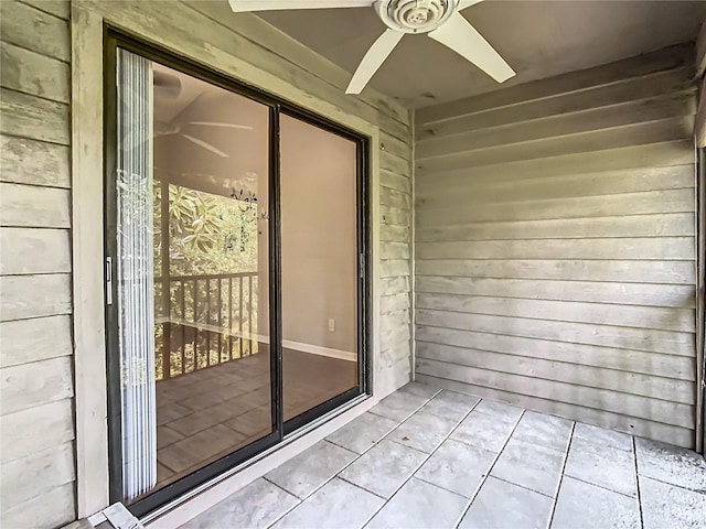 view of exterior entry with ceiling fan