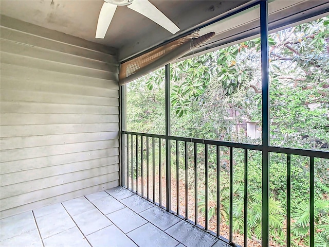 unfurnished sunroom featuring ceiling fan