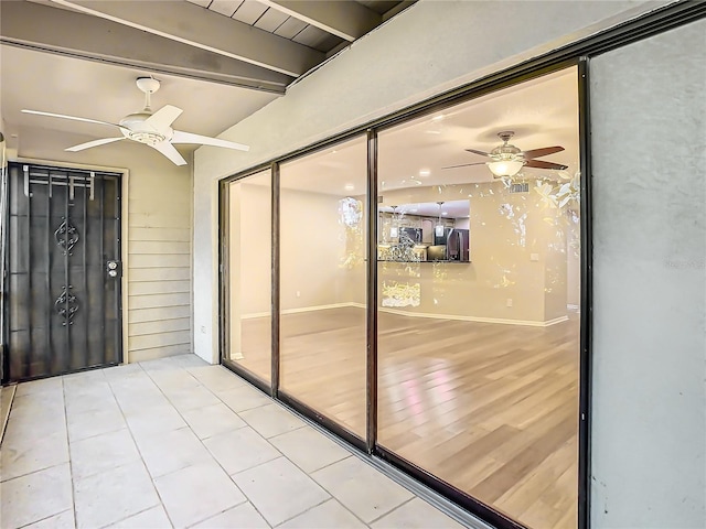 interior space with ceiling fan