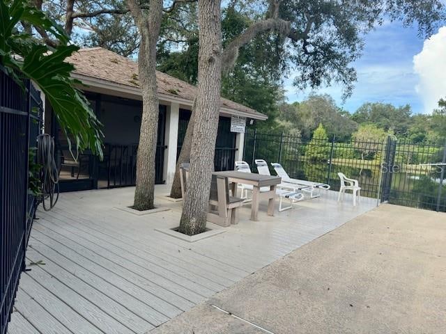 deck featuring a patio and a water view