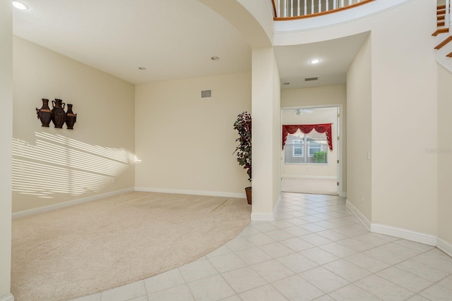 carpeted empty room with ceiling fan