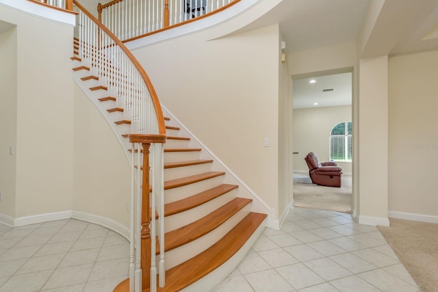 stairway featuring tile patterned flooring