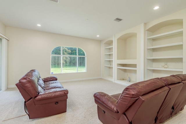 living room with light colored carpet and built in features