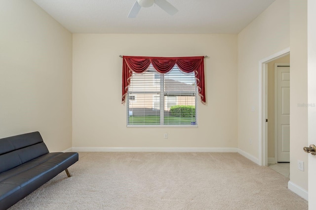 living area featuring ceiling fan and light colored carpet