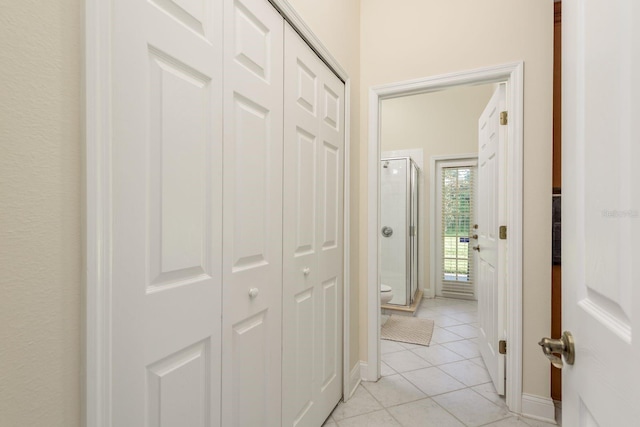 hall with light tile patterned floors