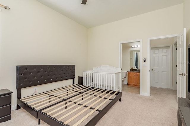 carpeted bedroom with connected bathroom and ceiling fan