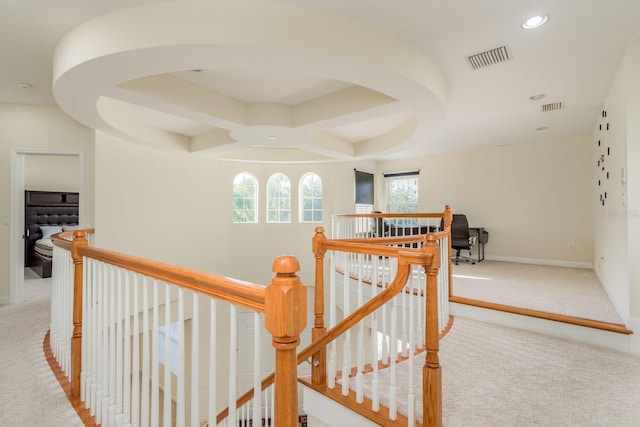 hallway featuring light colored carpet