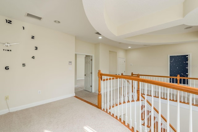 hall featuring light colored carpet