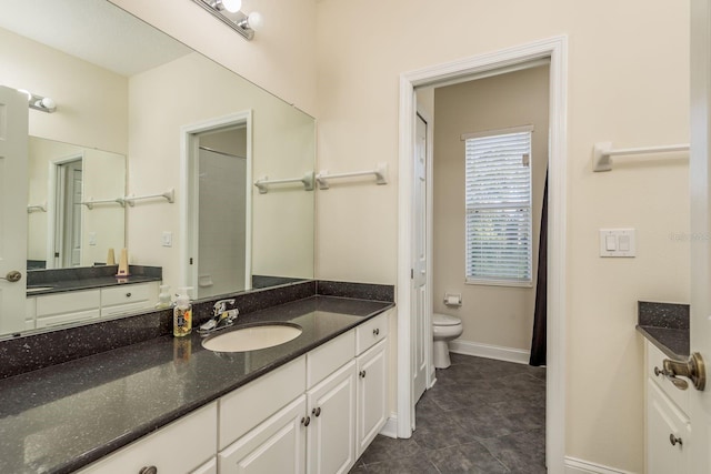 bathroom with tile patterned floors, vanity, and toilet