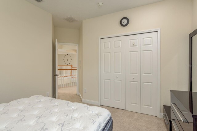 carpeted bedroom featuring a closet