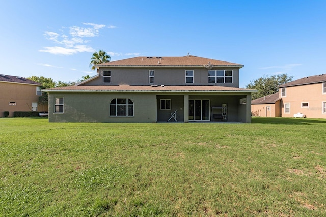 rear view of property with a lawn