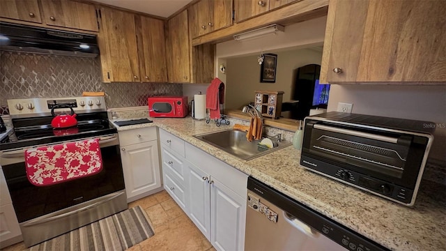 kitchen featuring sink, appliances with stainless steel finishes, tasteful backsplash, white cabinetry, and extractor fan