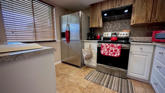 kitchen with backsplash, white cabinets, and stainless steel appliances