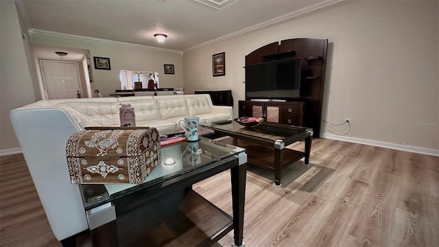 living room with hardwood / wood-style floors and crown molding