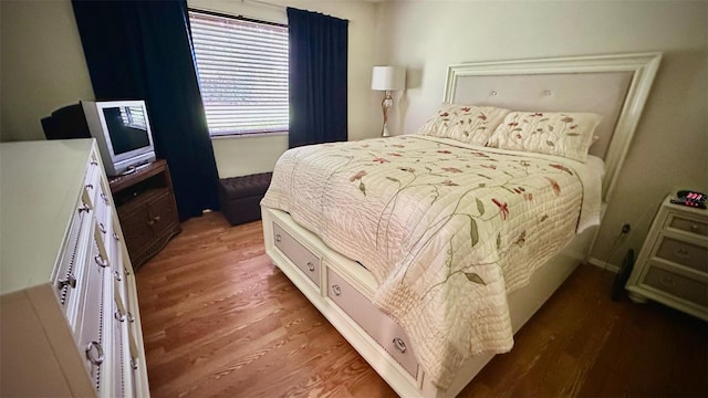 bedroom featuring dark hardwood / wood-style flooring