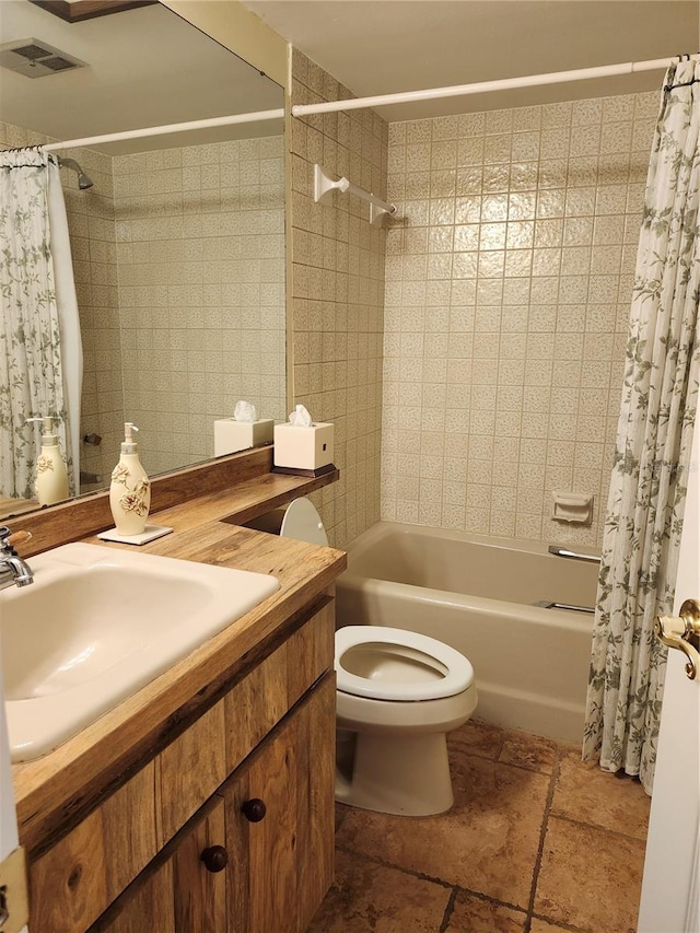 full bathroom featuring shower / bath combo with shower curtain, vanity, and toilet