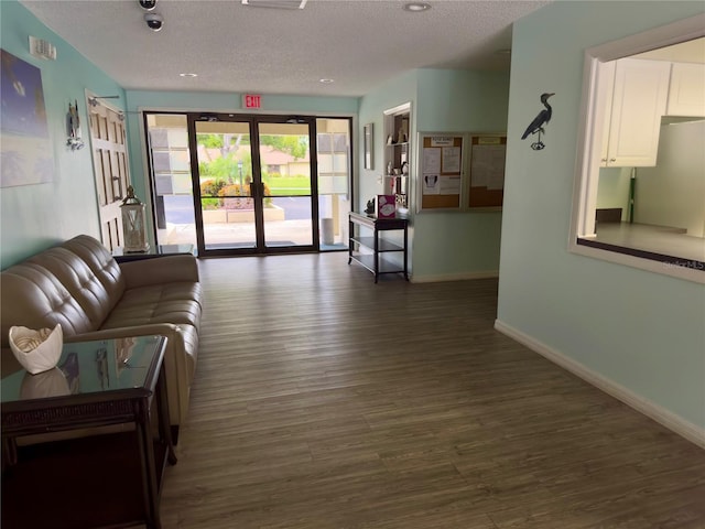 living room featuring dark hardwood / wood-style floors and a textured ceiling