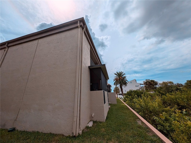 view of side of property with a lawn