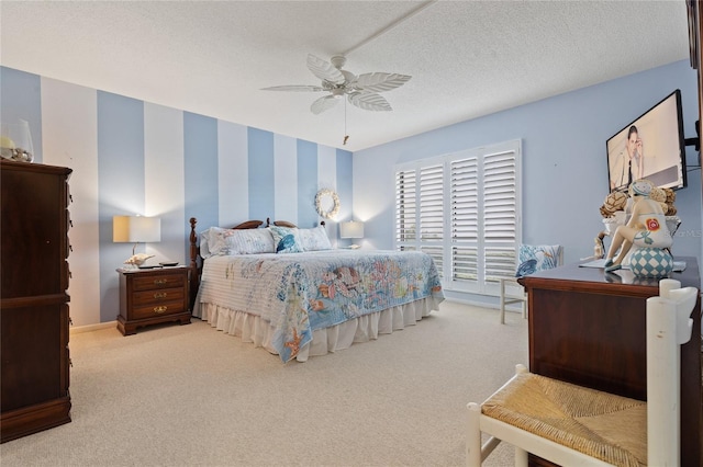 carpeted bedroom featuring a textured ceiling and ceiling fan