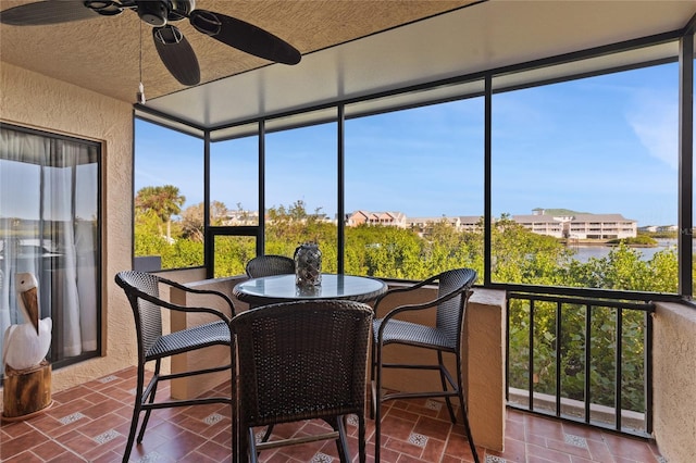 sunroom / solarium featuring ceiling fan