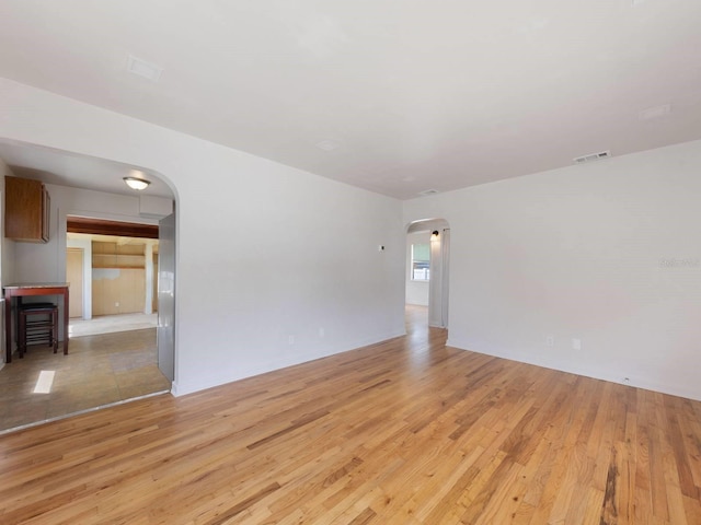 empty room with light hardwood / wood-style flooring