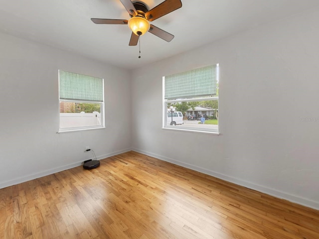 empty room featuring ceiling fan and light hardwood / wood-style floors